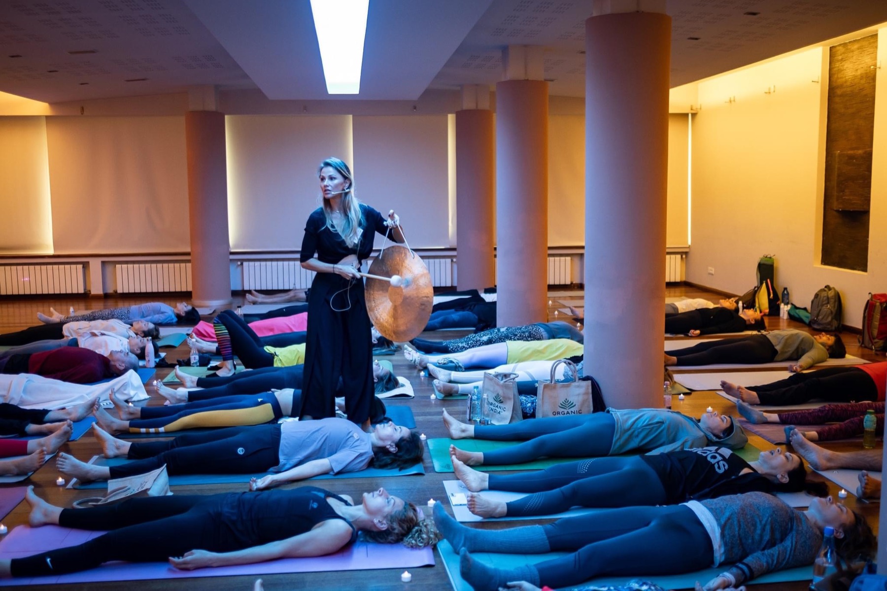 Jani facilitating a group practice with a gong